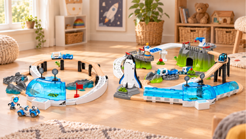 Two separate space-themed wooden railway scenes on a warm wooden floor, with the smaller station beside the larger elevated scene.