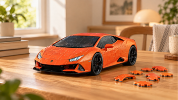 Orange Huracán-shaped 3D puzzle model with visible interlocking seams and loose orange puzzle pieces on a warm wooden desk.