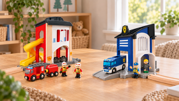 Red and white fire station with yellow slide and fire vehicles, beside a blue and white police station with van and figures on a wooden table.